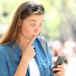 Democrat’s 2018 Video Could SINK Senate Run Woman looking surprised at smartphone outdoors