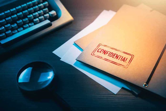 Confidential file folder on desk with magnifying glass and typewriter