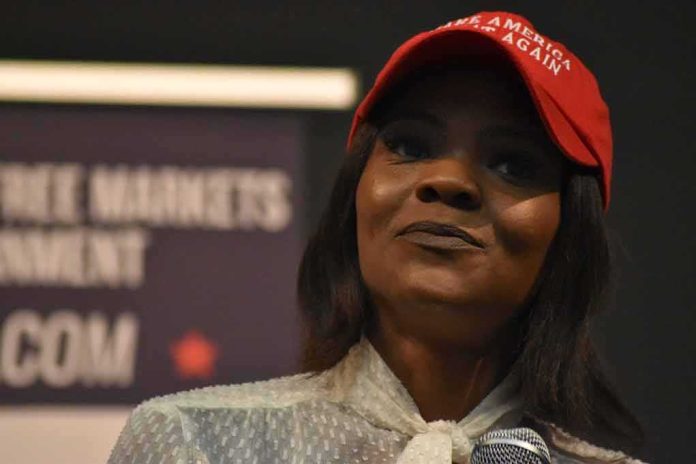 woman in a red cap speaking into a microphone