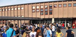 School Choice Money Opens to 96% of Kids Students gathered outside a school building entrance
