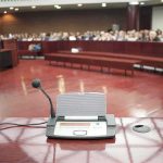 Mayor LUNGES at Resident During Public Meeting Conference microphone on a podium in a courtroom