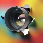 Hidden CAMERA Found Where Young Gymnasts Changed camera lens emerging through torn paper on colorful background