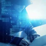 Actor/Comedian Lands on UK Counter-Terror Radar Hooded figure using a laptop with digital code overlay