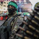 Muslim Brotherhood Question RATTLES El-Sayed armed person in camouflage with face covering on a city street