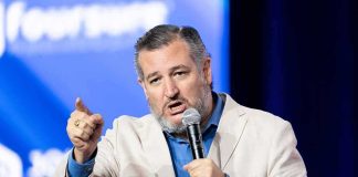 man speaking into microphone on stage