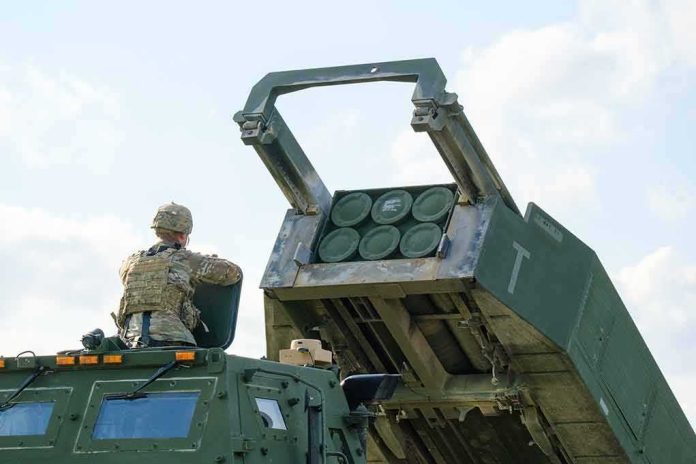 Soldier beside a military rocket launcher vehicle