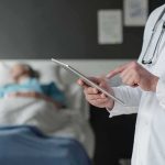 Vatican Transparency Stuns – What’s Still Hidden? Doctor using tablet beside hospital patient