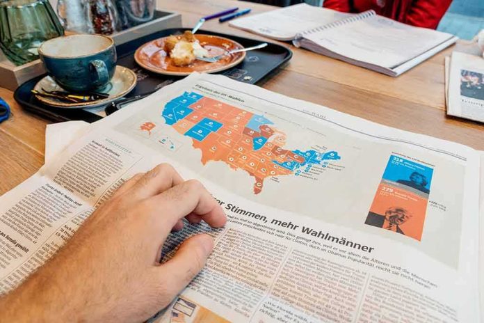 shutterstock_514397911-1 Hand holding newspaper with US election map at a cafe table