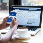 How Adults Could Be Forced to Show ID ONLINE Hands using smartphone with laptop and coffee on cafe table