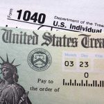 60M Kids Got Trump Investment Accounts Close-up of a U.S. Treasury check and tax form 1040